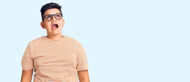 Küçük çocuk günlük kıyafetler ve gözlük takıyor kızgın ve kızgın bağırıyor sinirli ve öfkeli, öfkeyle bağırıyor. öfke ve agresif konsept. 