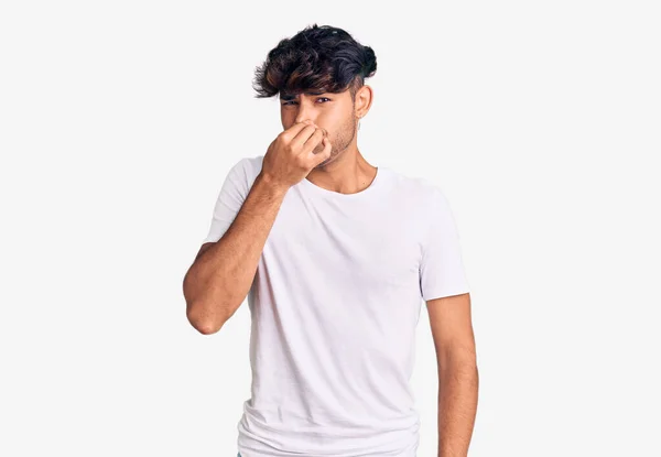 Young Hispanic Man Wearing Casual Clothes Smelling Something Stinky Disgusting — Stock Photo, Image