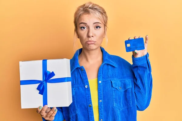 Young Blonde Girl Holding Gift Credit Card Depressed Worry Distress — Stock Photo, Image