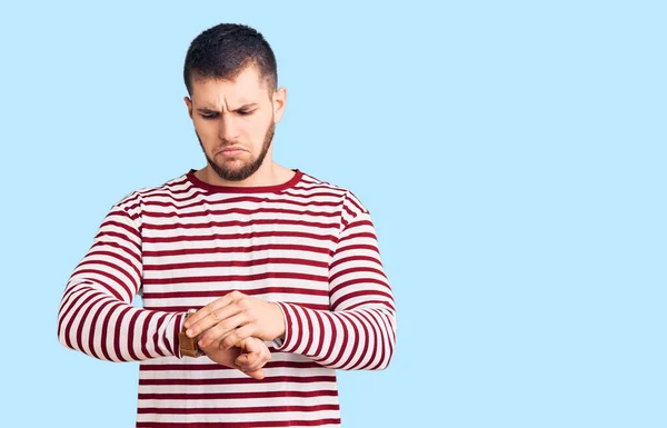 Young Handsome Man Wearing Striped Sweater Checking Time Wrist Watch — Stock Photo, Image