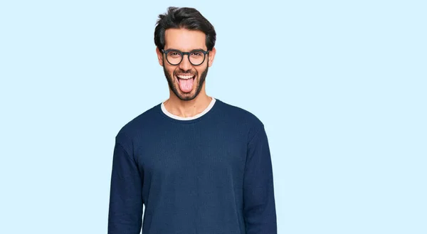 Young Hispanic Man Wearing Casual Clothes Glasses Sticking Tongue Out — Stock Photo, Image