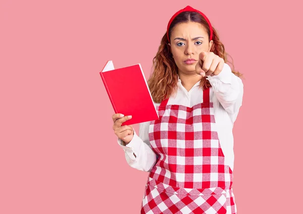 Mujer Latina Joven Usando Delantal Sosteniendo Libro Recetas Señalando Con —  Fotos de Stock