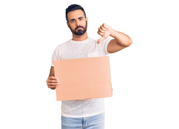 Young Hispanic Man Holding Banner Cardboard Angry Face Negative Sign — Fotografia de Stock