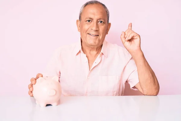 Senior Handsome Man Gray Hair Holding Piggy Bank Sitting Table — Stock Photo, Image