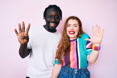 Irklar arası çift günlük kıyafetler giyer ve dokuz numaralı parmaklarıyla gülümseyerek mutlu ve kendinden emin görünürler.. 