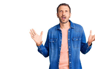 Genç, yakışıklı, sıradan kıyafetler giyen çılgın ve deli gibi bağıran agresif bir ifade ve kollarla bağıran bir adam. hüsran kavramı. 