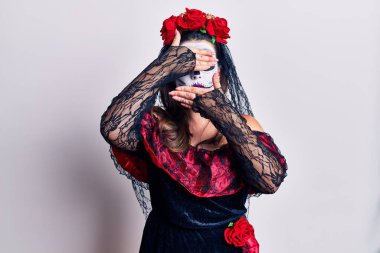 Genç bir kadın, ölü kostümünü beyaz gözleri ve ağzı kapalı, şaşırmış ve şok olmuş bir şekilde giyer. duygu gizleme 