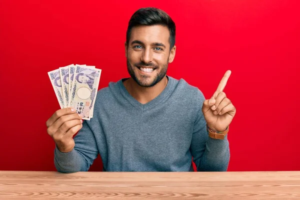 Bonito Homem Hispânico Segurando Notas Iene Japonês Sorrindo Feliz Apontando — Fotografia de Stock