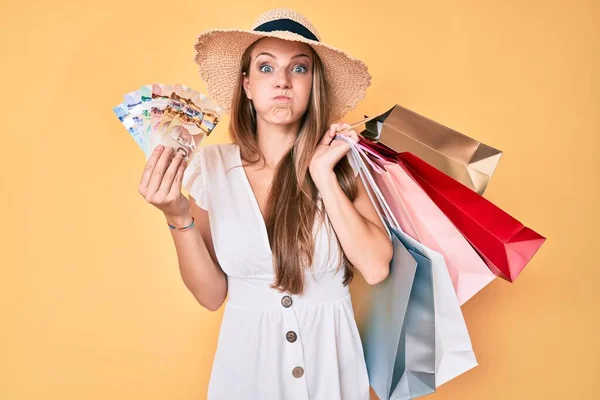 Young Blonde Girl Holding Shopping Bags Canadian Dollars Puffing Cheeks — Stock Photo, Image
