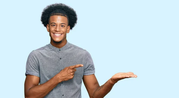 African American Man Afro Hair Wearing Casual Clothes Amazed Smiling — Stock Photo, Image