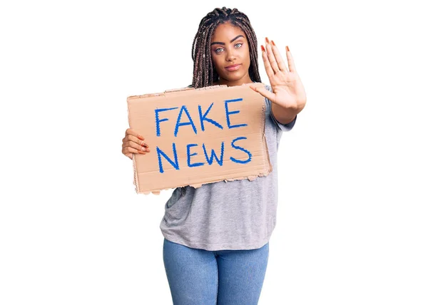 Young African American Woman Braids Holding Fake News Banner Open — ストック写真