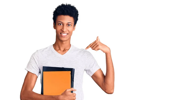 Jovem Afro Americano Segurando Livro Apontando Dedo Para Auto Sorrindo — Fotografia de Stock