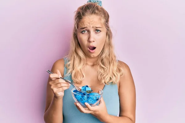 Young Blonde Girl Eating Measure Meter Doing Diet Weight Loss — Fotografia de Stock