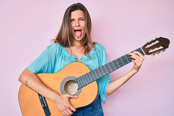 Beautiful Caucasian Woman Playing Classical Guitar Sticking Tongue Out Happy — Stock Photo, Image