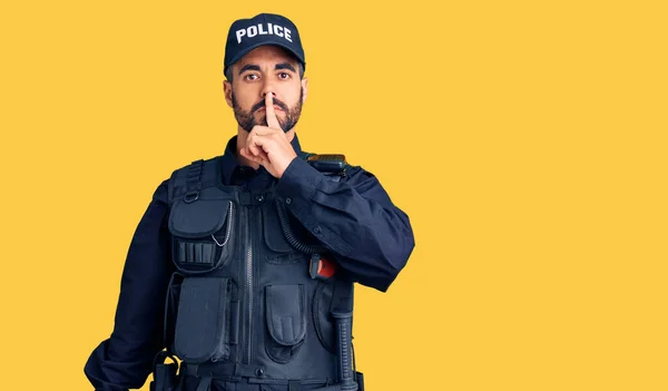 Young Hispanic Man Wearing Police Uniform Asking Quiet Finger Lips — 图库照片