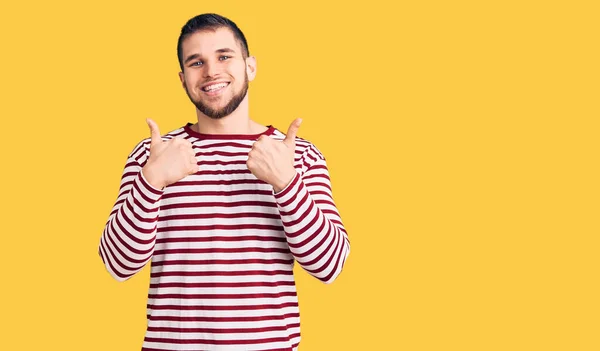 Young Handsome Man Wearing Striped Sweater Success Sign Doing Positive — 图库照片