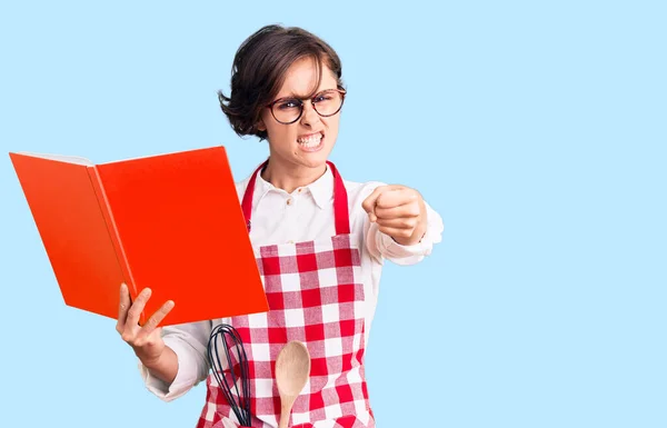 Schöne Junge Frau Mit Kurzen Haaren Trägt Professionelle Bäckerschürze Kochrezeptbuch — Stockfoto