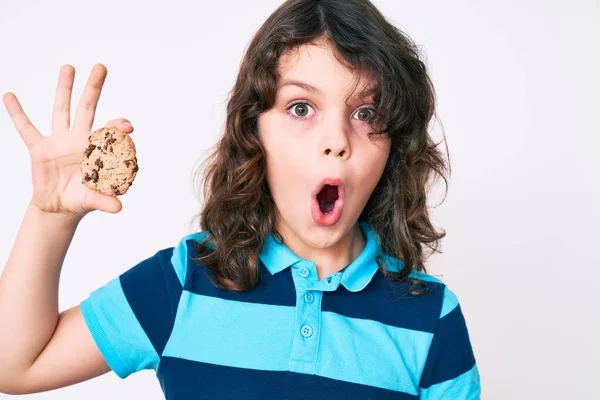 Cute Hispanic Child Long Hair Holding Cookie Scared Amazed Open — Stock Photo, Image