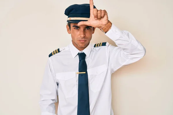 Young Hispanic Man Wearing Airplane Pilot Uniform Making Fun People — Stock Photo, Image