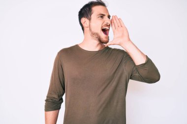 Sıradan kıyafetler giyen genç yakışıklı adam el ele verip bağırarak ve yüksek sesle bağırıyor. iletişim konsepti. 