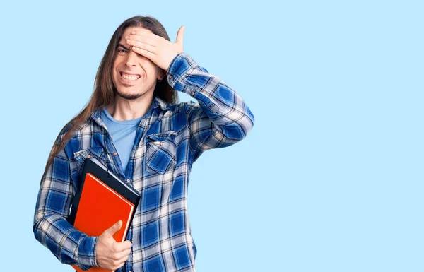 Young Adult Man Long Hair Holding Collage Book Stressed Frustrated — Stock Photo, Image