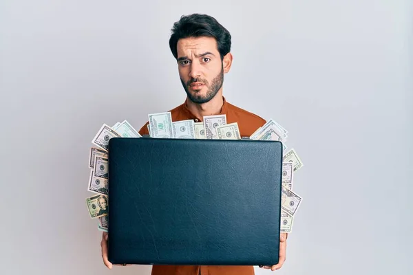 Young Hispanic Man Holding Briefcase Dollars Clueless Confused Expression Doubt — Stock Photo, Image
