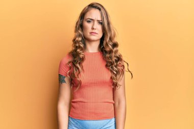 Sıradan kıyafetler giyen, kuşkucu ve gergin genç sarışın kız sorun yüzünden üzgün. negatif kişi. 