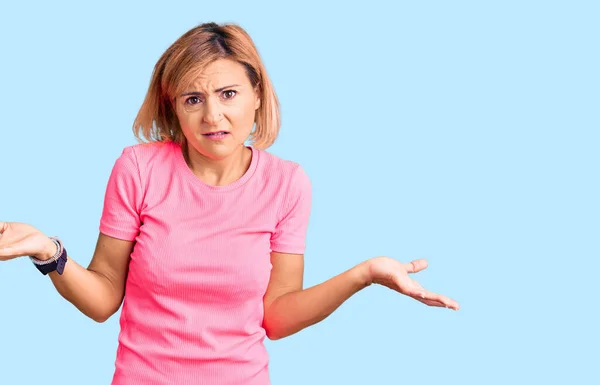 Young Blonde Woman Wearing Sportswear Clueless Confused Open Arms Idea — Stock Photo, Image