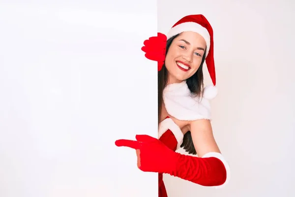 Young Woman Wearing Santa Claus Costume Holding Blank Empty Banner — Stock Photo, Image