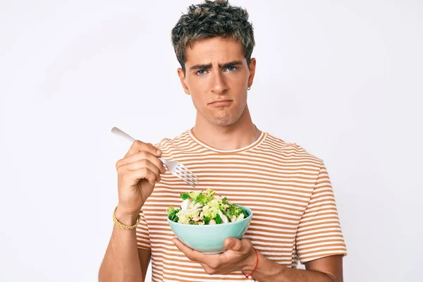 Young Handsome Man Eating Salad Skeptic Nervous Frowning Upset Because — Stock Photo, Image