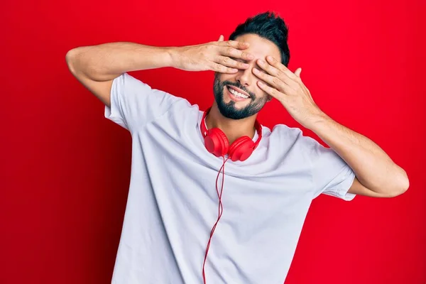 Young Man Beard Listening Music Using Headphones Covering Eyes Hands — Stock Photo, Image