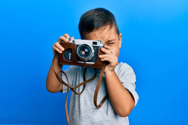 Adorable Latin Photographer Toddler Smiling Happy Using Vintage Camera Isolated — Stock Photo, Image