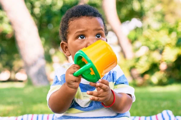 Adorable African American Chubby Toddler Playing Toy Sitting Grass Park — Stock Photo, Image