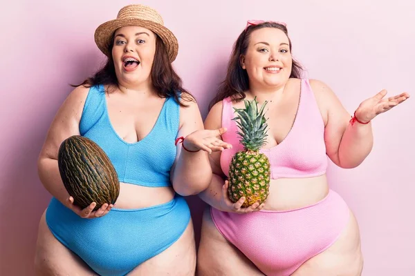 Młode Bliźnięta Size Bikini Trzymające Melona Ananasa Świętujące Osiągnięcie Szczęśliwym — Zdjęcie stockowe