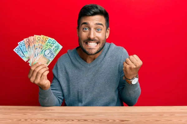 Hombre Hispano Guapo Sosteniendo Dólares Australianos Gritando Orgulloso Celebrando Victoria —  Fotos de Stock