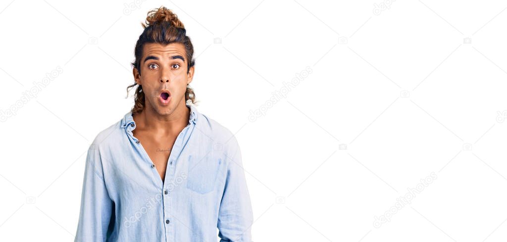 Young hispanic man wearing summer style afraid and shocked with surprise and amazed expression, fear and excited face. 