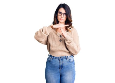 Beautiful young brunette woman wearing casual clothes and glasses doing time out gesture with hands, frustrated and serious face 