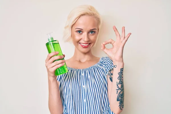 Young Blonde Woman Tattoo Holding Aloe Vera Doing Sign Fingers — Fotografia de Stock