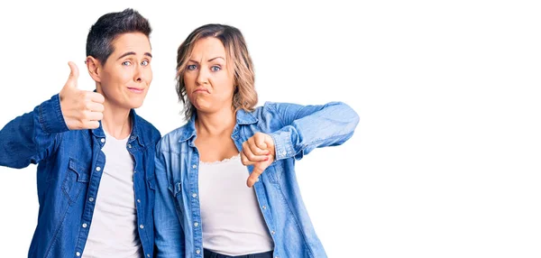 Couple Women Wearing Casual Clothes Doing Thumbs Disagreement Agreement Expression — Stock Photo, Image