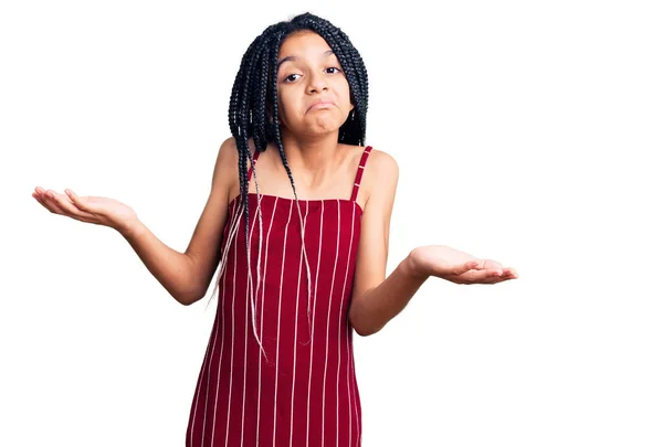 カジュアルな服を着たかわいいアフリカ系アメリカ人の少女は 腕や手を上げて混乱した表情 疑わしい概念 — ストック写真