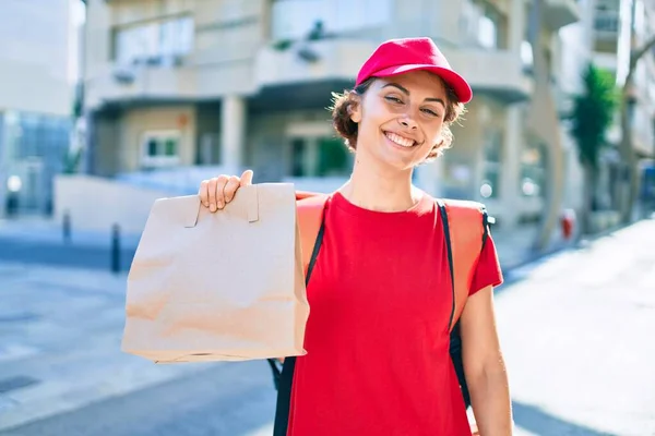 Delivery business worker woman wearing uniform and delivery bag smiling happy