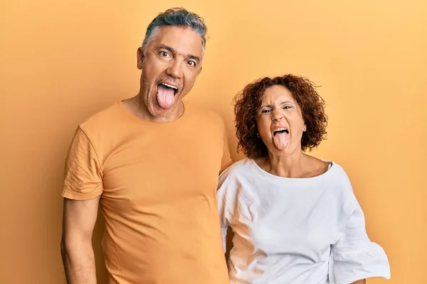 Beautiful Middle Age Couple Together Wearing Casual Clothes Sticking Tongue — Stock Photo, Image