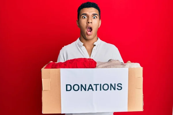 Young Arab Man Holding Donation Box Clothes Afraid Shocked Surprise — Stock Photo, Image
