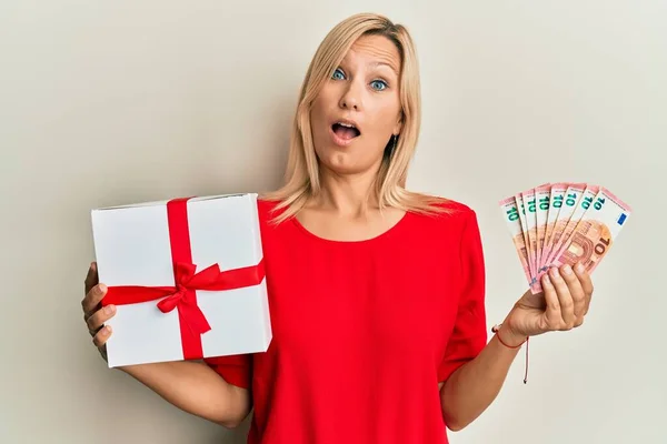 Middle Age Caucasian Woman Holding Gift Euros Banknotes Shock Face — Stock Photo, Image