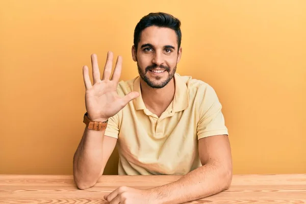 Young Hispanic Man Wearing Casual Clothes Sitting Table Showing Pointing — Stock Photo, Image