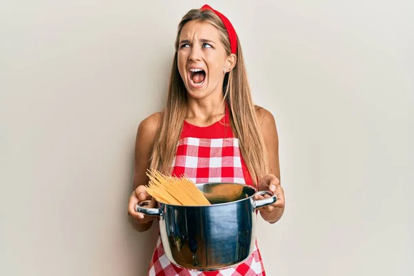 Young Blonde Woman Wearing Professional Baker Apron Holding Cooking Pot — Stock Photo, Image