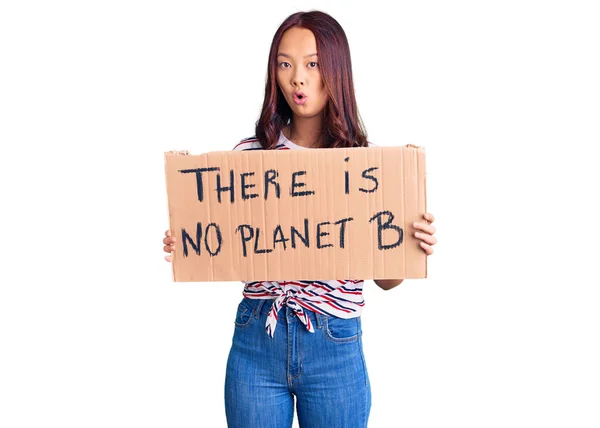 Young Beautiful Chinese Girl Holding Planet Banner Scared Amazed Open — Stock Photo, Image