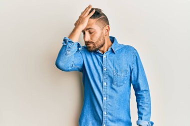 Sıradan kot ceket giyen, sakallı yakışıklı bir adam. Yanlışlıkla eli kafasında şaşırmış. Hatayı hatırla. Unuttum, kötü hafıza kavramı. 