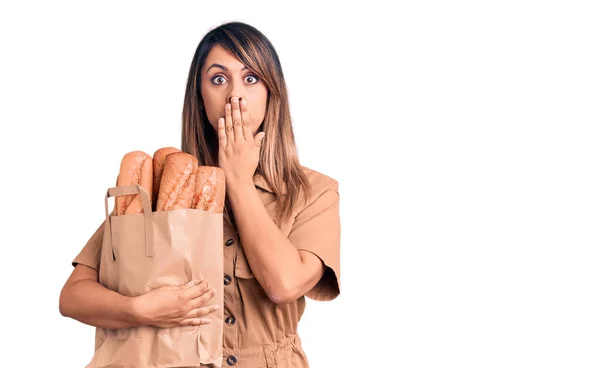 Young Beautiful Woman Holding Paper Bag Bread Covering Mouth Hand — Stock Photo, Image