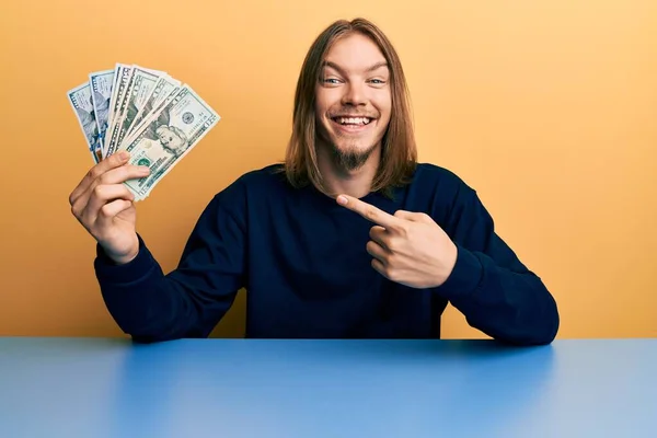 Handsome Caucasian Man Long Hair Holding Dollars Smiling Happy Pointing — Stock Photo, Image